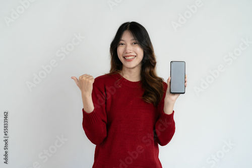 Asian long haired black woman holding smartphone feeling very happy Excited and surprised hand gestures Studio portrait isolated on white background