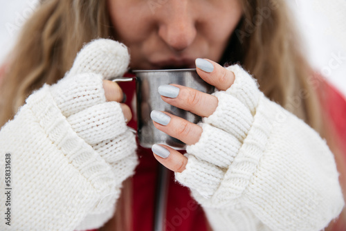 Young woman drinks a cup of...