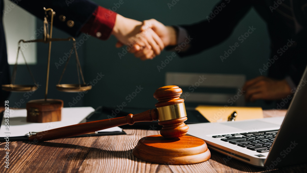 Business and lawyers discussing contract papers with brass scale on desk in office. Law, legal services, advice, justice and law concept picture with film grain effect