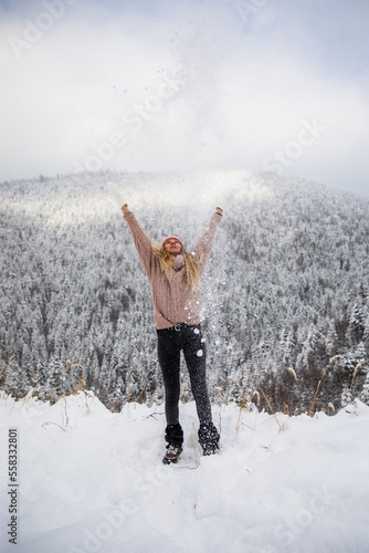 Happy young girl is tossing...