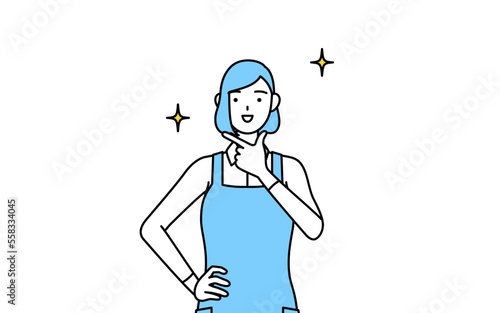 自信家のポーズを取るエプロンを着た女性