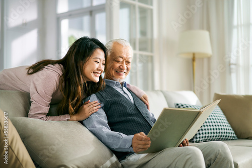 asian elderly father and adult daughter having a good time