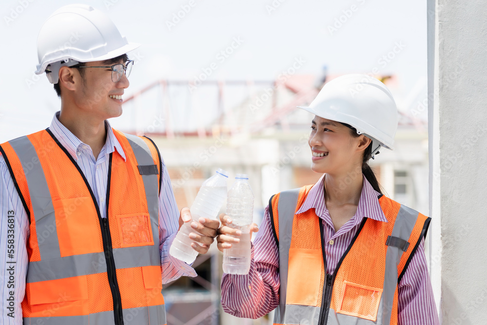 Close-up The workers construction house workers drink water. An engineer team or worker is tired happy Close-up The workers construction house workers drink water. An engineer team or worker is tired happy