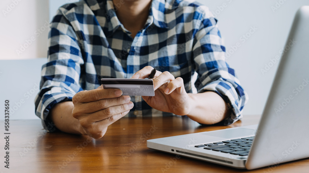 Hands holding credit card and using laptop. Online shopping Hands holding credit card and using laptop. Online shopping