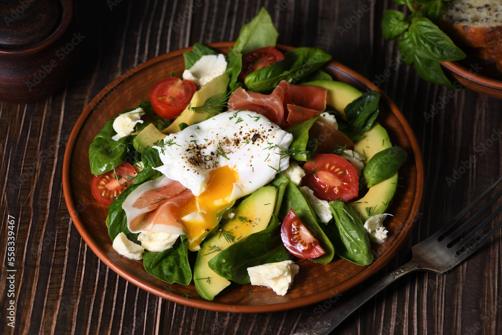 Eggs Benedict (Poached) with Parma ham, slices of avocado, tomato and tender spinach leaves, seasoned with flavored spicy olive oil Eggs Benedict (Poached) with Parma ham, slices of avocado, tomato and tender spinach leaves, seasoned with flavored spicy olive oil