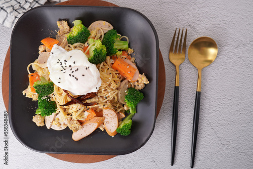 Stir-fried noodles with pork and egg, fresh vegetables, top view