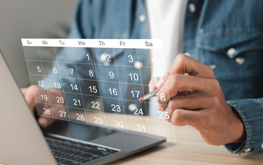 Businessman manages time for effective work. Calendar on the virtual screen interface. Highlight appointment reminders and meeting agenda on the calendar. Time management concept.
