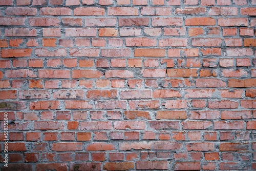 Red brick wall. City buildings. Brick background. Repair, construction. Weathered stained old brick wall background.