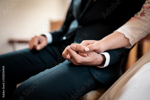 Love is in the air  young couple is holding hands  detail on rings wedding day
