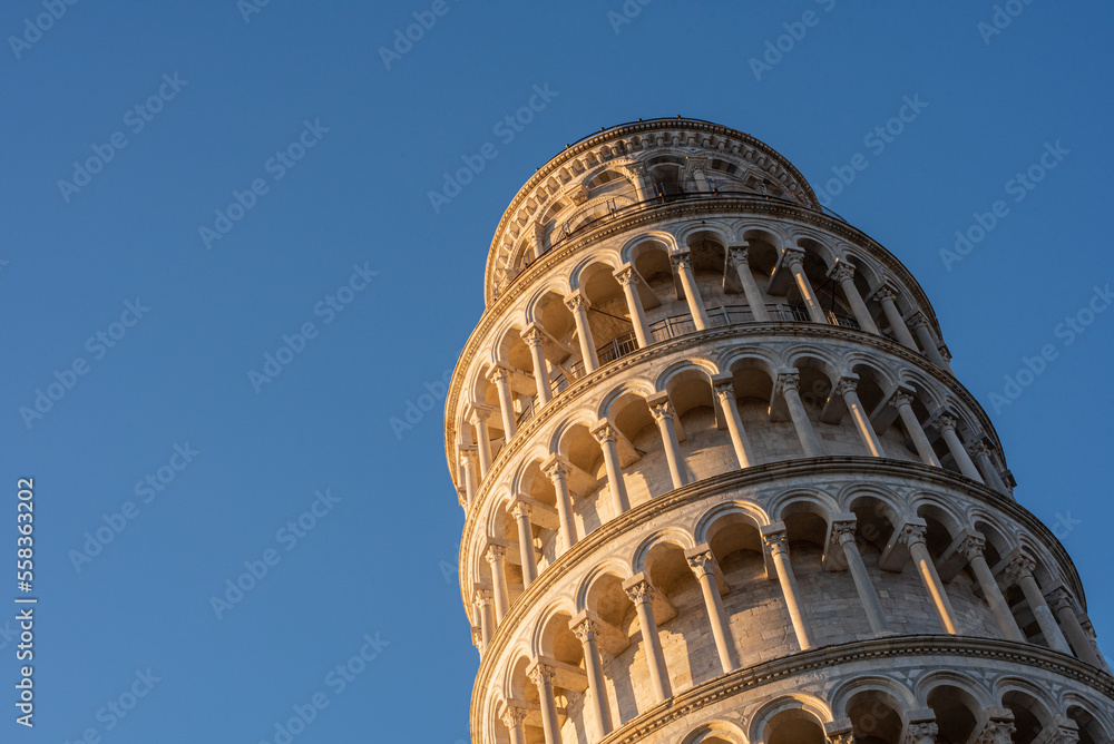 Low angle view of the Pisa tower against blue clear sky.