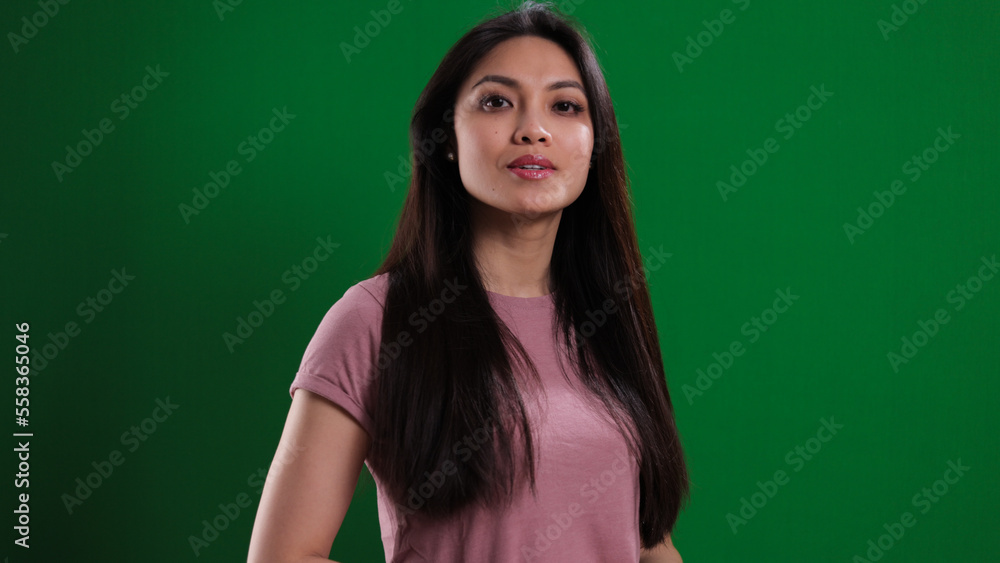 Young pretty woman in the studio posing against a green background - studio photography Young pretty woman in the studio posing against a green background - studio photography