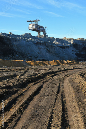 Bucket-wheel excavator during excavation at the surface mine. Huge excavator on open pit mine.