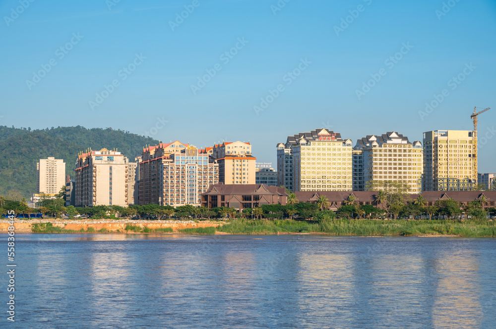 Condominium and other buildings in Bokeo province in Laos view look through Mekong river from Chiang Saen district of Thailand border.
