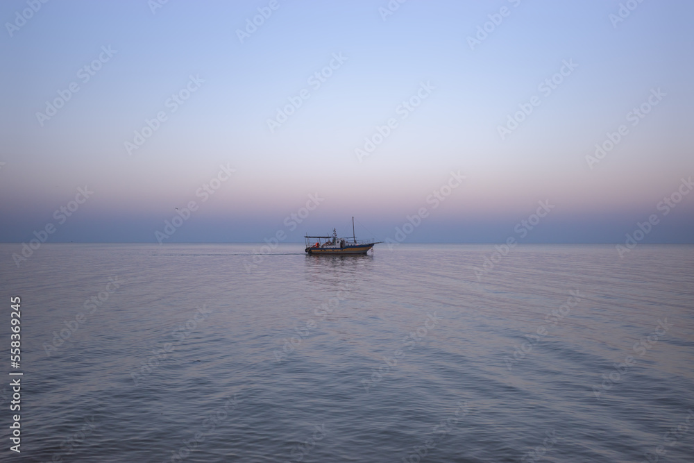Lonely fishing boat at sea during twilight. Lonely fishing boat at sea during twilight.