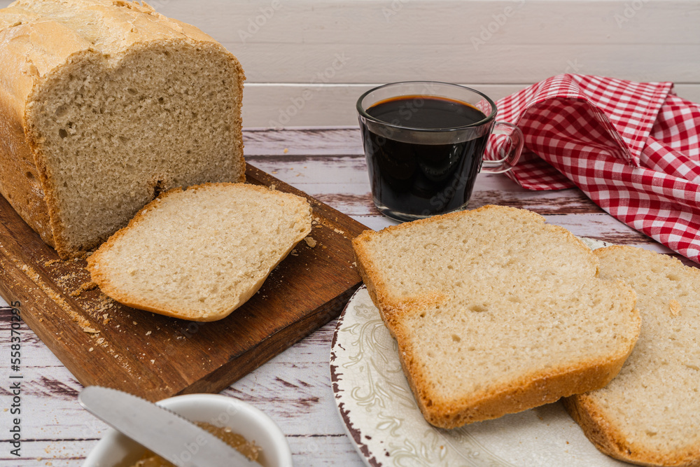Overhead view of a homemade bread, slices and some sweet in a pot on a rustic tableNormal view of a homemade bread made with a bread machine, slices on a plate and some sweet in a pot on a table Overhead view of a homemade bread, slices and some sweet in a pot on a rustic tableNormal view of a homemade bread made with a bread machine, slices on a plate and some sweet in a pot on a table