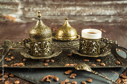 traditional turkish coffee in vintage cup in metal service, anise, roasted beans on brown background 5