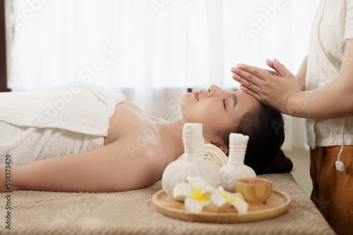 Young woman doing relaxing massage in spa salon. Female being massaged by a masseur. Spa and medicine concept