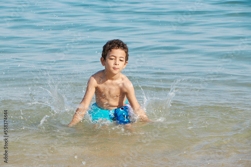 Happy child playing in the sea. Kid having fun outdoors. Summer vacation and healthy lifestyle concept.  © Mostafa Eissa