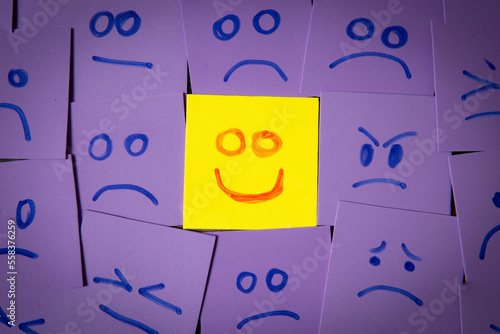 Tableau sur toile Concept of a happy face amongst despair representing belief and a positive attit