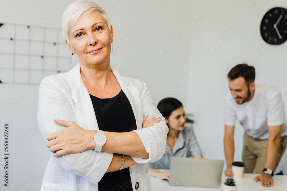 Fototapeta premium older business woman, successful confidence with arms crossed