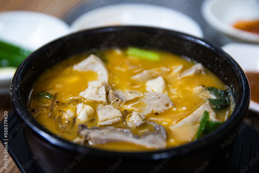 Boiled beef intestines, japchae, soybean paste, vegetables, and green onions in an earthen pot, Korean traditional food,