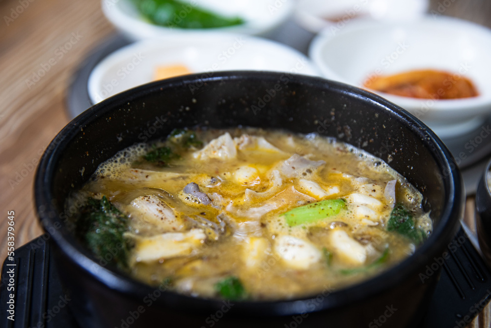 Boiled beef intestines, japchae, soybean paste, vegetables, and green onions in an earthen pot, Korean traditional food,