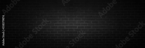 black brick wall background. dark stone texture with light effect