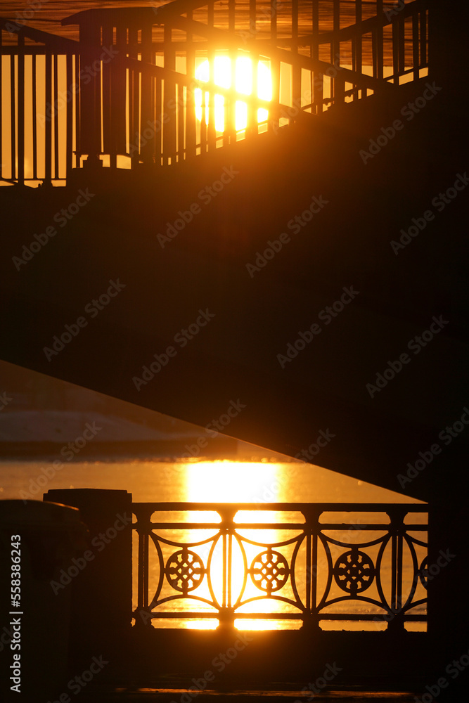Silhouette of metal fences and handrails on the background of the sunset Silhouette of metal fences and handrails on the background of the sunset