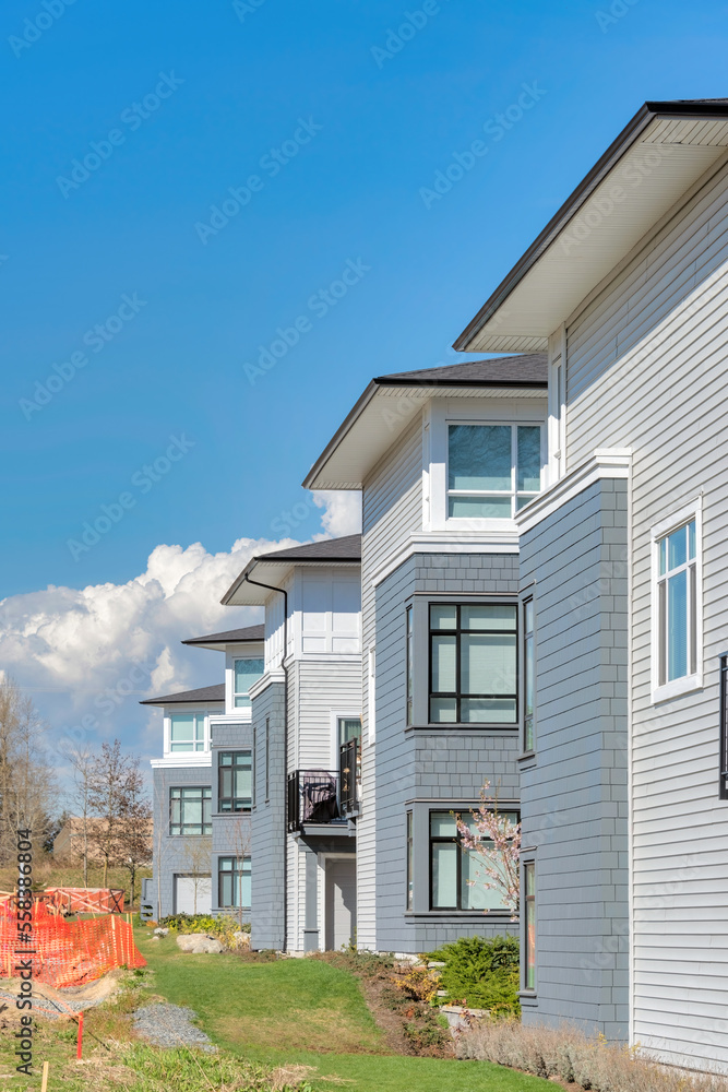Brand new residential townhouses on blue sky background Brand new residential townhouses on blue sky background