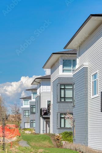 Brand new residential townhouses on blue sky background © Imagenet