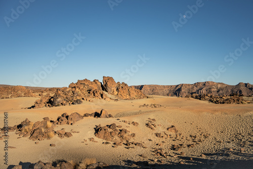 The deserted volcanic landscape of Minas de San José, rocks, sand and tourists under the moon in the Teide National Park on the island of Tenerife