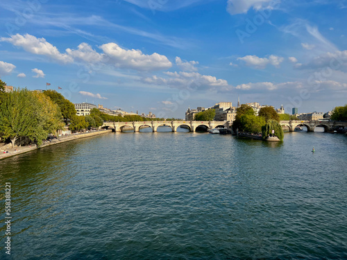 The Pont Neuf bridge over the Seine river in Paris. This Arched stone bridge opened in 1607, with 2 spans and a bronze, equine statue of King Henri IV.