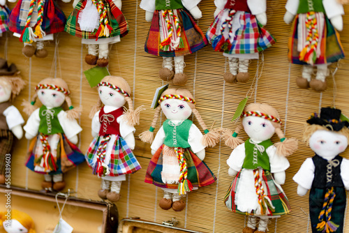 Cute handmade ragdoll dolls in Lithuanian national costumes sold on Easter market in Vilnius.