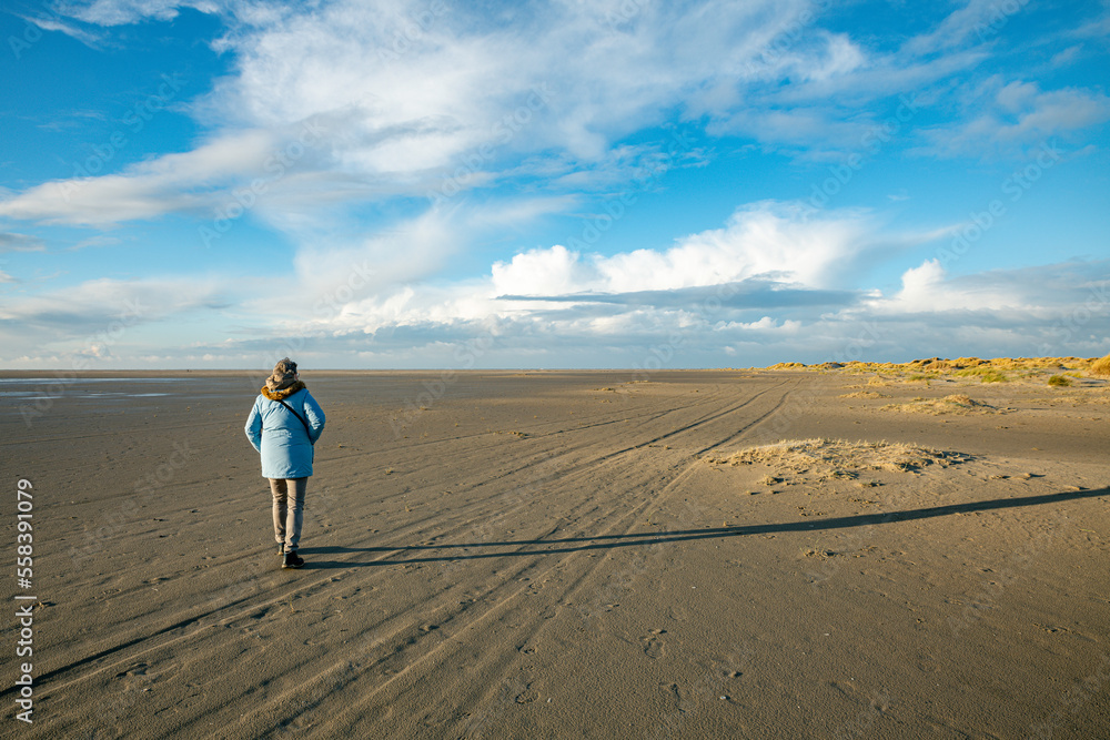 woman wlaking on the south part of the island texel