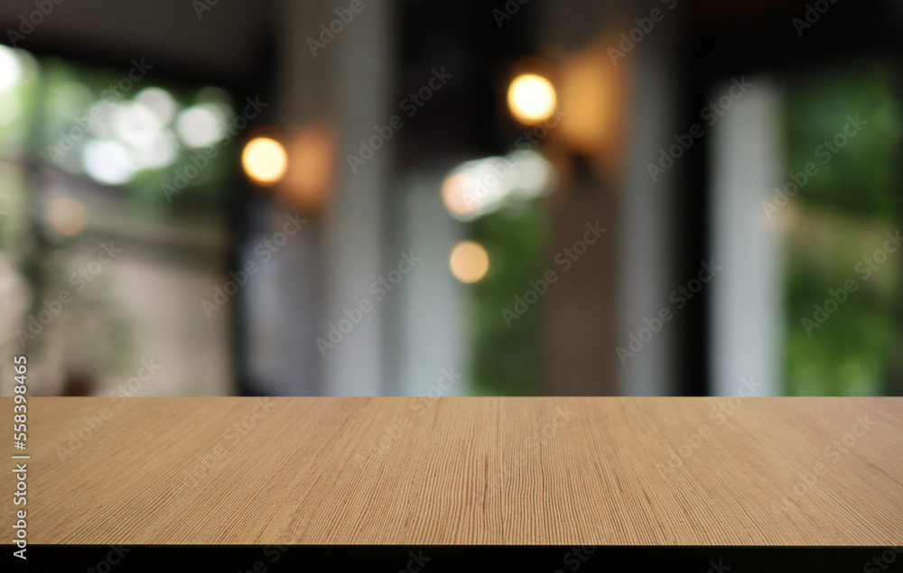 Empty wooden table in front of abstract blurred background of coffee shop . can be used for display or montage your products.Mock up for display of product Empty wooden table in front of abstract blurred background of coffee shop . can be used for display or montage your products.Mock up for display of product