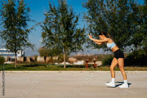 Lovely girl in sportswear is about to do a cartwheel © qunica.com