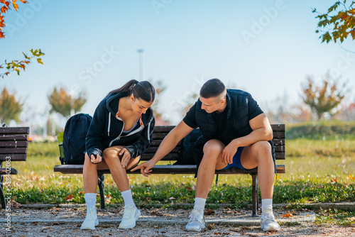 A man pointing at her girlfriend's leg