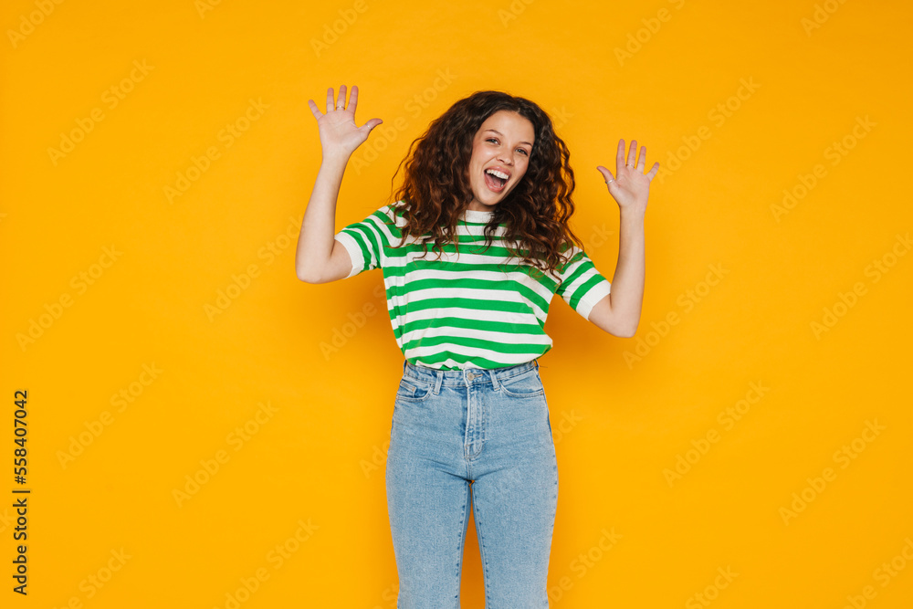 Young brunette woman wearing t-shirt laughing and gesturing at camera Young brunette woman wearing t-shirt laughing and gesturing at camera