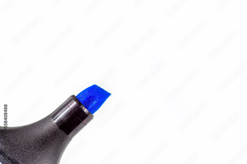 Black marker pen with bright blue tip on light background close up with copy space. Black marker pen with bright blue tip on light background close up with copy space.