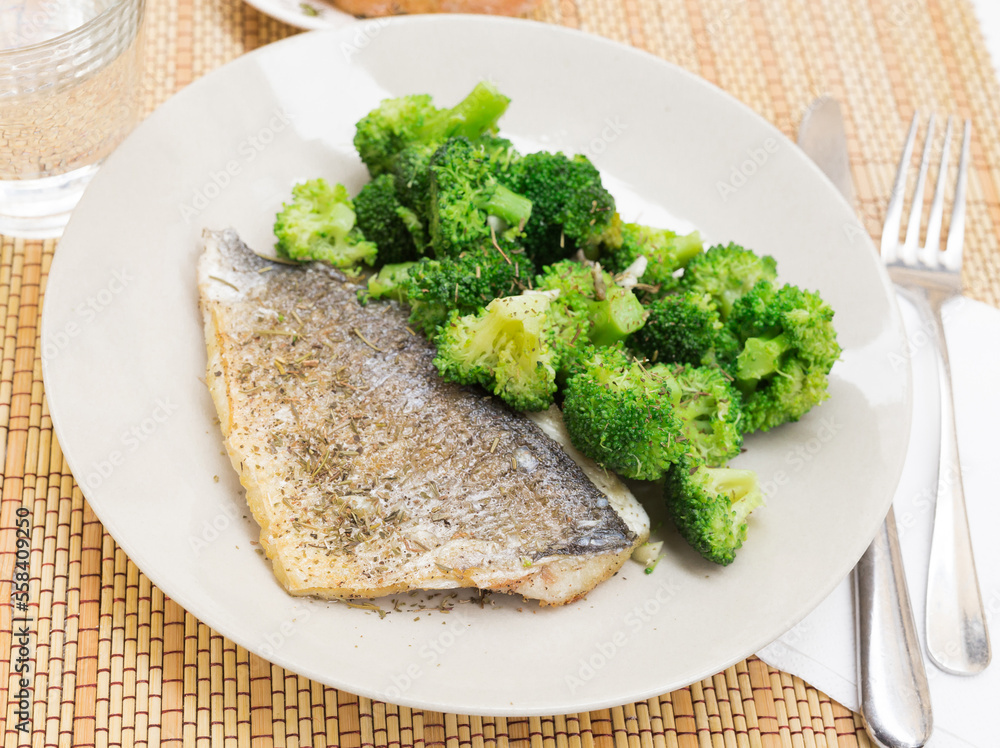 dish of fried dorado fish fillet with boiled broccoli dish of fried dorado fish fillet with boiled broccoli