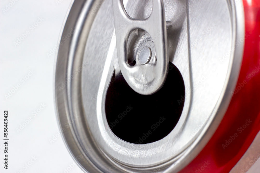 Opened metal aluminum can with soda drink close up on light background with copy space. Opened metal aluminum can with soda drink close up on light background with copy space.