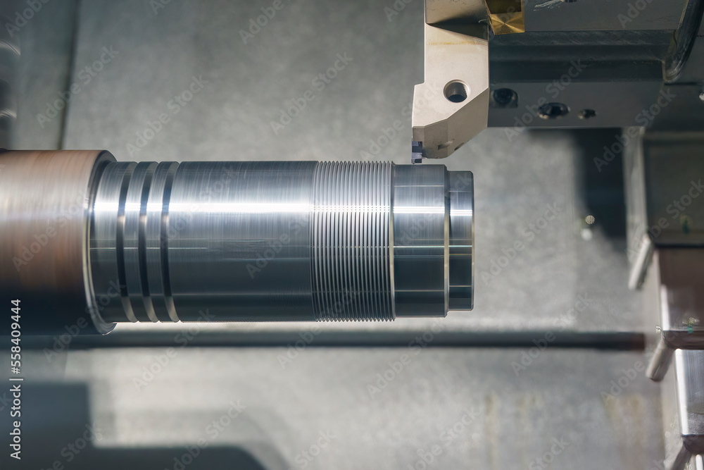 The CNC lathe machine thread cutting at the metal shaft parts. The CNC lathe machine thread cutting at the metal shaft parts.