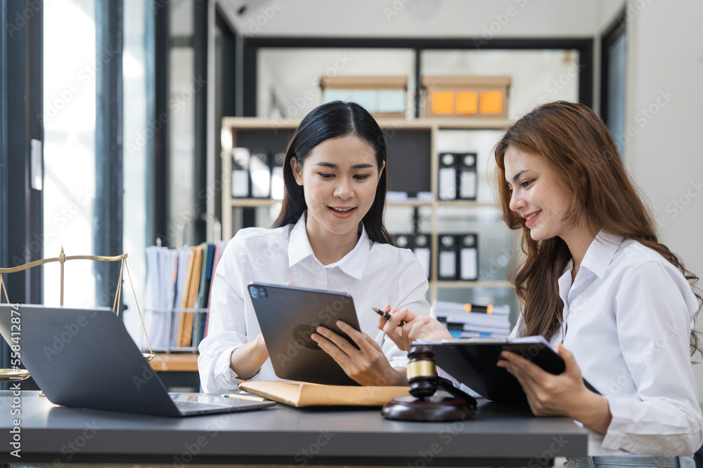 Business law concept, Lawyer business lawyers are consulting lawyers for women entrepreneurs to file copyright lawsuit with laptop and tablet Business law concept, Lawyer business lawyers are consulting lawyers for women entrepreneurs to file copyright lawsuit with laptop and tablet