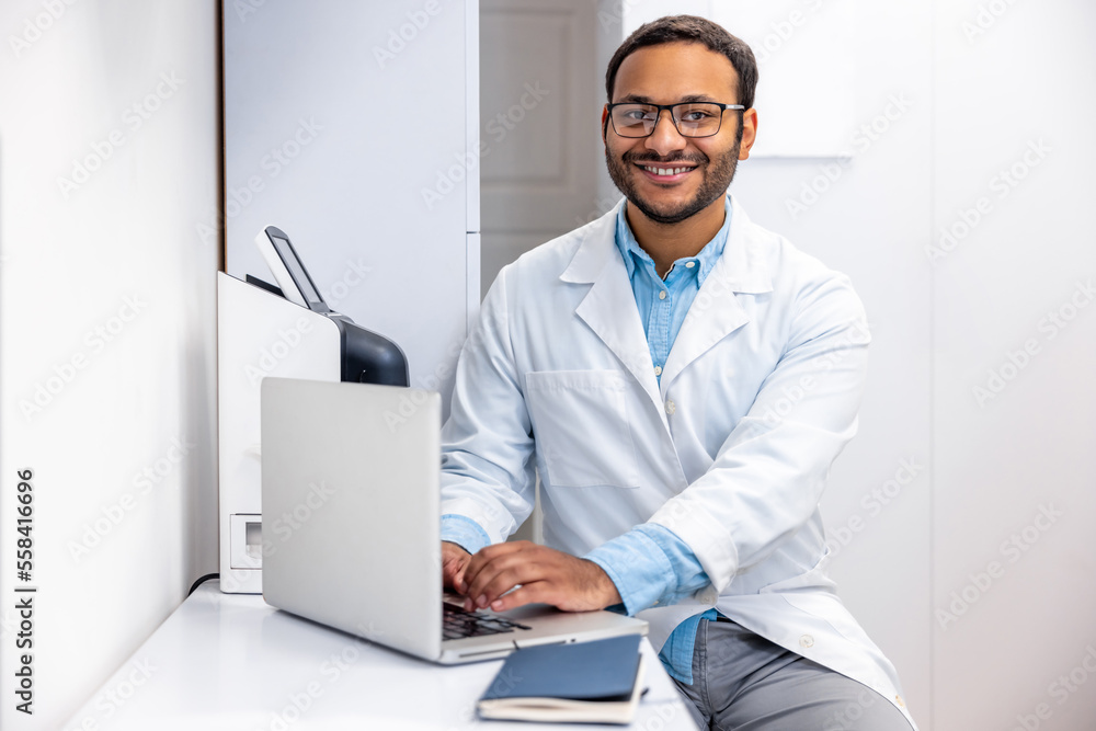 Male doctor in lab coat at his working palce