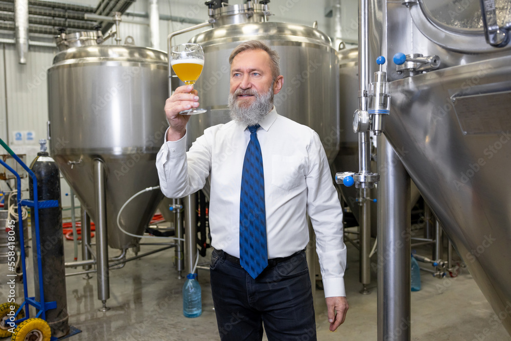 Brewer tasting a beverage at a beer plant Brewer tasting a beverage at a beer plant