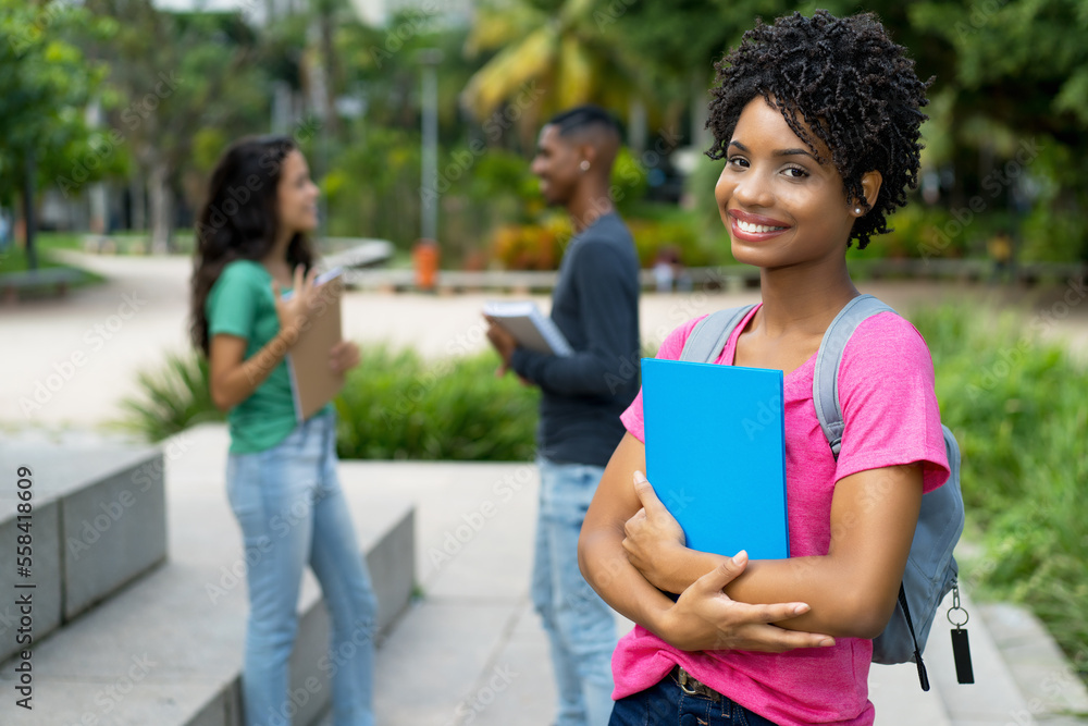 Happy brazilian female student with group of friends Happy brazilian female student with group of friends