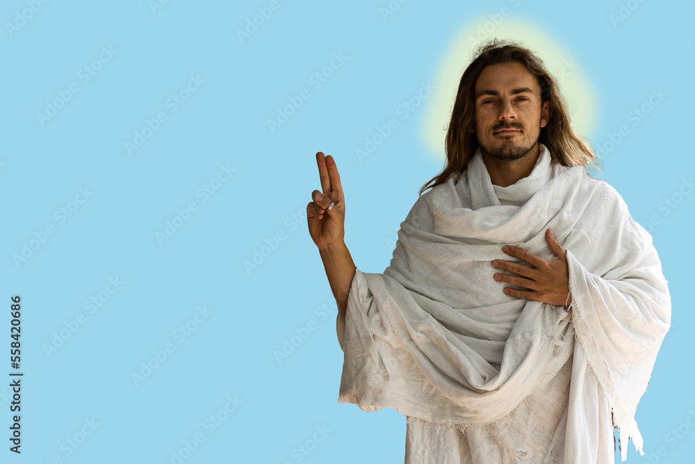 Holy Jesus-type handsome man in white robes against a blue background with finger symbol