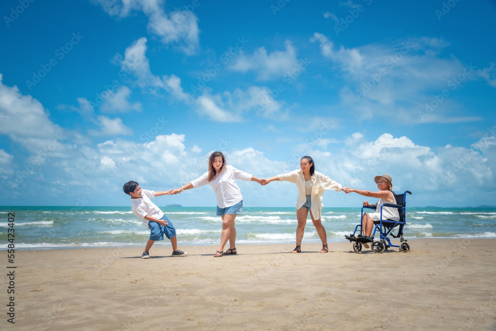 Happy Asian diversity generation family standing on tropical beach in summer at daytime