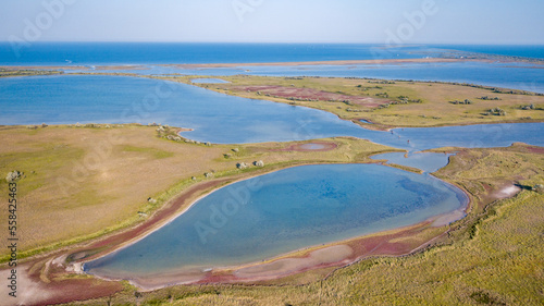 amazing aerial view of blue and pink lakes  sea on horizon. Beautiful natural landscape. Drone shot  bird s eye.