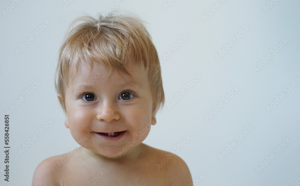 Little, happy and smiling cute baby in the studio. Portrait of a one year old baby. The concept of happiness. Little, happy and smiling cute baby in the studio. Portrait of a one year old baby. The concept of happiness.